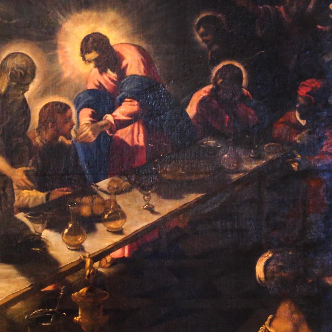 Christ giving the bread, vessels running away down the length of the table.